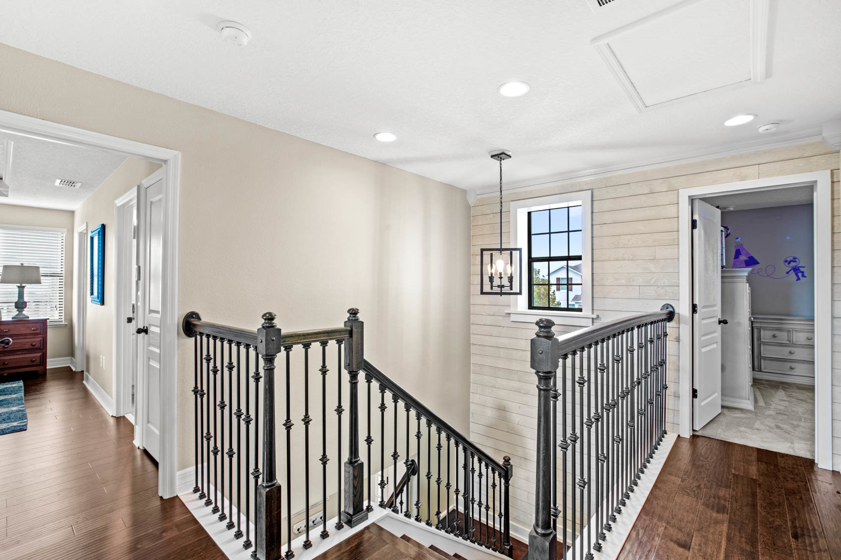 top of the stairs with black wooden handrails